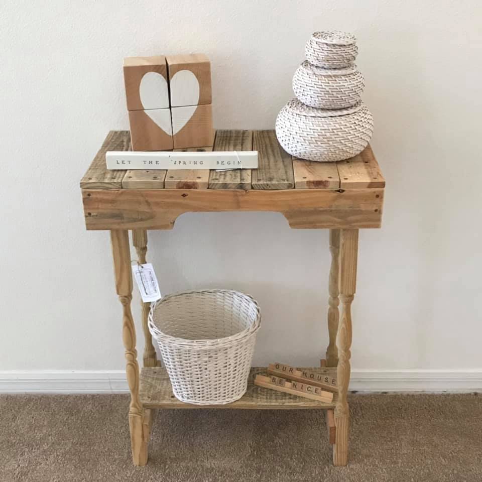 A side table with baskets and signs on top