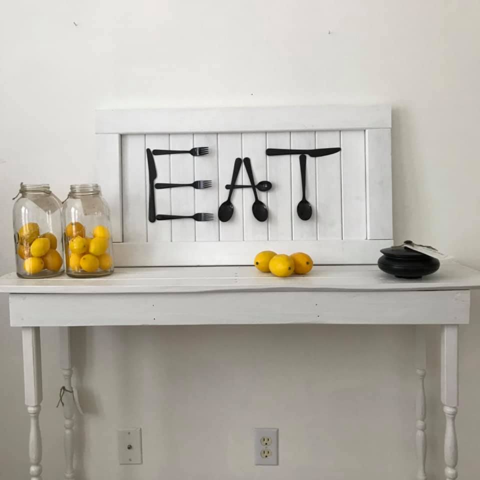 Nice "EAT" sign showing on the white colored side table